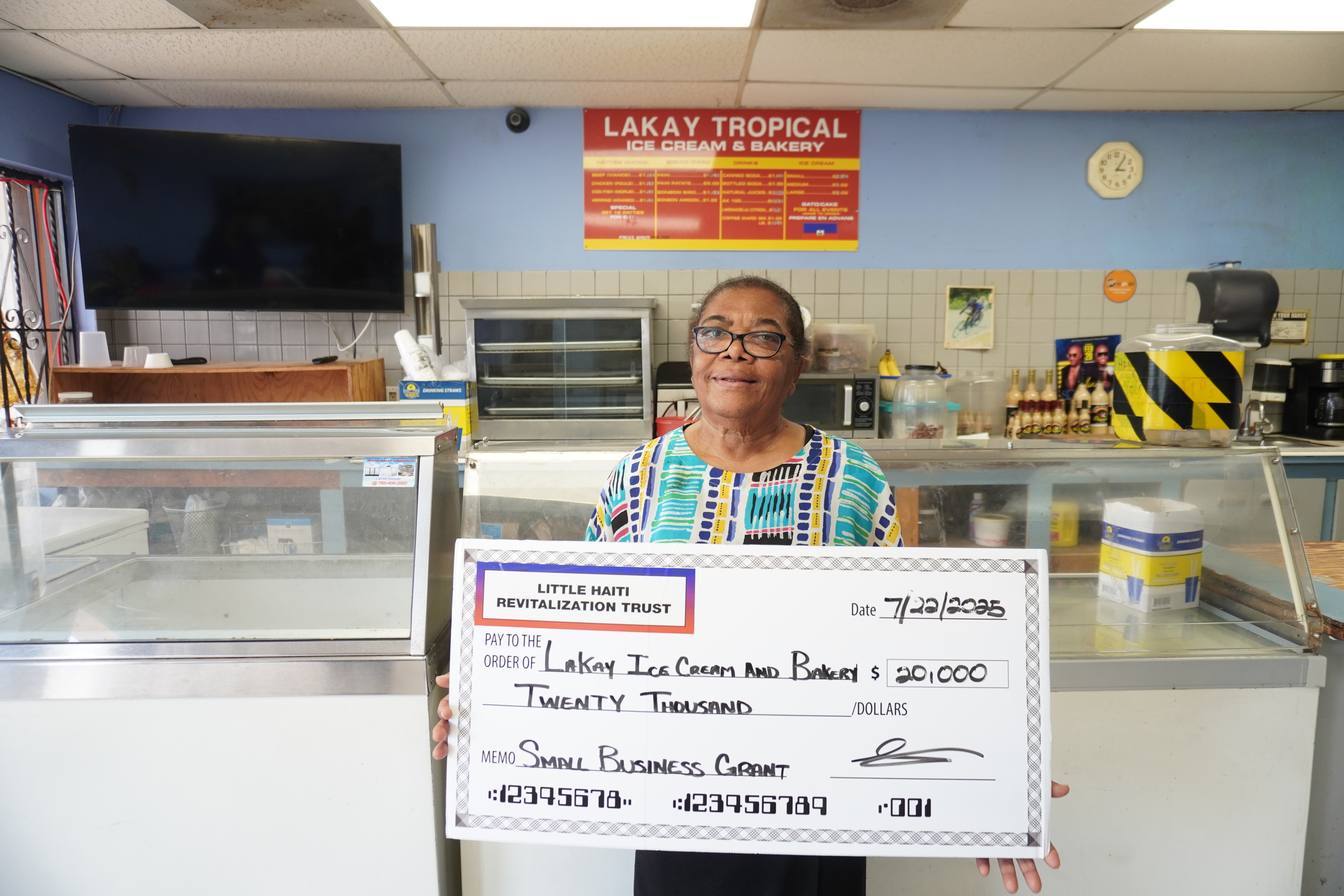 Business owner holding check
